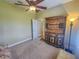 Bright bedroom with ceiling fan and built-in shelving at 9240 Se 128Th Ln, Summerfield, FL 34491
