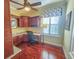 Home office with built-in cabinetry, granite countertops, and hardwood floors at 9240 Se 128Th Ln, Summerfield, FL 34491