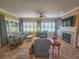 Spacious living room with a fireplace and large windows at 9240 Se 128Th Ln, Summerfield, FL 34491