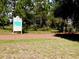 Nature trail entrance with signage and paved path at 9240 Se 128Th Ln, Summerfield, FL 34491