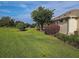 Landscaped backyard with manicured lawn and shrubs at 9240 Se 128Th Ln, Summerfield, FL 34491