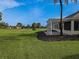 Covered patio overlooks a lush green golf course at 9240 Se 128Th Ln, Summerfield, FL 34491