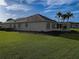 Side view showcasing a well-maintained lawn and landscaping at 9240 Se 128Th Ln, Summerfield, FL 34491