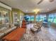 Bright sunroom with ample seating and outdoor views at 9240 Se 128Th Ln, Summerfield, FL 34491