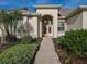 Inviting home exterior with landscaped walkway and lush greenery at 9240 Se 128Th Ln, Summerfield, FL 34491