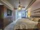Main bedroom with king-size bed and built-in entertainment center at 9240 Se 128Th Ln, Summerfield, FL 34491