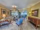 Spacious living room featuring comfortable seating and large windows at 9240 Se 128Th Ln, Summerfield, FL 34491