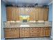 View of kitchen with granite countertops and wood cabinets at 9240 Se 128Th Ln, Summerfield, FL 34491