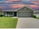 One-story house with a green exterior and a two-car garage at 4426 Nw 2Nd Ct, Ocala, FL 34475