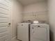 Well-lit laundry room complete with washer, dryer, and storage at 4426 Nw 2Nd Ct, Ocala, FL 34475