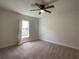 Well-lit bedroom with carpeted floor and ceiling fan at 4426 Nw 2Nd Ct, Ocala, FL 34475