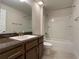 Bathroom boasts a bathtub, vanity with dark brown cabinets and a granite countertop at 4426 Nw 2Nd Ct, Ocala, FL 34475