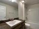 Clean bathroom with a tub, vanity, and dark brown cabinets at 4426 Nw 2Nd Ct, Ocala, FL 34475