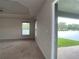 Spacious bedroom with carpet flooring, neutral walls, and access to backyard at 4426 Nw 2Nd Ct, Ocala, FL 34475