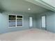 Covered back patio with two doors and window at 4426 Nw 2Nd Ct, Ocala, FL 34475