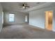 Main bedroom with carpeted floor, ceiling fan, and ensuite bathroom access at 4426 Nw 2Nd Ct, Ocala, FL 34475