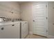 Bright laundry room with washer, dryer, and shelving at 4426 Nw 2Nd Ct, Ocala, FL 34475