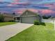 One-story house with a green exterior and a two-car garage at 4426 Nw 2Nd Ct, Ocala, FL 34475