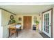 Covered patio with table and chairs, great for outdoor dining at 12369 Se 130Th Ct, Ocklawaha, FL 32179