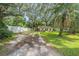 House with large grassy yard and mature trees at 12369 Se 130Th Ct, Ocklawaha, FL 32179