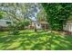Spacious backyard with lush grass and large trees at 12369 Se 130Th Ct, Ocklawaha, FL 32179