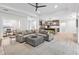 Open living room with sectional sofa and view into kitchen area at 1620 Nw 73Rd Ter, Ocala, FL 34482