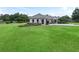 A light-colored house with a nicely landscaped yard at 1620 Nw 73Rd Ter, Ocala, FL 34482