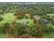 Aerial view of house on a large lot surrounded by trees at 1620 Nw 73Rd Ter, Ocala, FL 34482