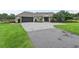 Single-story home with a large driveway and landscaped lawn at 1620 Nw 73Rd Ter, Ocala, FL 34482