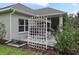 Home's exterior with a patio, swing, and trellis at 1620 Nw 73Rd Ter, Ocala, FL 34482