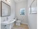 Small bathroom with toilet and pedestal sink at 1620 Nw 73Rd Ter, Ocala, FL 34482