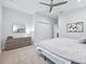 Bright bedroom with a large bed, dresser, and mirror at 1620 Nw 73Rd Ter, Ocala, FL 34482