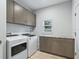 Laundry room with washer, dryer, and ample cabinetry at 1620 Nw 73Rd Ter, Ocala, FL 34482