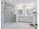 Modern bathroom with double vanity and chevron tile shower at 1620 Nw 73Rd Ter, Ocala, FL 34482