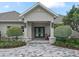 Elegant front entrance with double doors and landscaping at 1620 Nw 73Rd Ter, Ocala, FL 34482