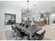Modern dining room with sleek table and six black chairs at 1620 Nw 73Rd Ter, Ocala, FL 34482