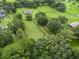 Aerial view of a house with large green lawn and fenced pastures at 1620 Nw 73Rd Ter, Ocala, FL 34482