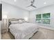 King-size bed in spacious bedroom with large window at 1620 Nw 73Rd Ter, Ocala, FL 34482