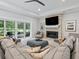 Relaxing living room featuring a stone fireplace and sliding glass doors at 1620 Nw 73Rd Ter, Ocala, FL 34482