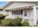 Charming front porch with tiled flooring, blue shutters, and white metal railings at 10978 Sw 83Rd Ave, Ocala, FL 34481
