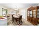 Bright dining room with hardwood floors and views into the kitchen and living room at 10978 Sw 83Rd Ave, Ocala, FL 34481