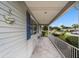 Inviting front porch with tiled flooring, blue shutters, and white metal railings at 10978 Sw 83Rd Ave, Ocala, FL 34481