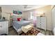 Cozy bedroom with light wood furniture and patterned bedding at 10978 Sw 83Rd Ave, Ocala, FL 34481