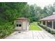 Small storage shed with paved patio area at 21389 Sw 102Nd Street Rd, Dunnellon, FL 34431