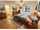Main bedroom with ensuite bathroom and wood-look floors at 21389 Sw 102Nd Street Rd, Dunnellon, FL 34431