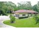 Home exterior showcasing large yard and driveway at 21389 Sw 102Nd Street Rd, Dunnellon, FL 34431
