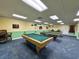 Game room with two pool tables and seating at 21389 Sw 102Nd Street Rd, Dunnellon, FL 34431