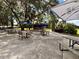 Outdoor patio with tables, umbrellas, and a stage at 21389 Sw 102Nd Street Rd, Dunnellon, FL 34431