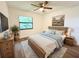 Main bedroom with a king-size bed and wood furniture at 21389 Sw 102Nd Street Rd, Dunnellon, FL 34431