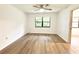 Simple bedroom with light walls and wood-look floors at 21389 Sw 102Nd Street Rd, Dunnellon, FL 34431